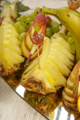 Very nice and artistically sliced fruits on a platter.