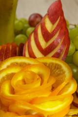 Very nice and artistically sliced fruits on a platter.