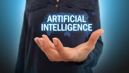 Businesswoman holding artificial intelligence text over world map