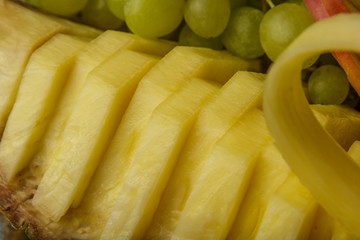 Very nice and artistically sliced fruits on a platter.