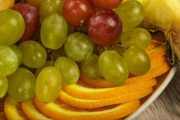 Very nice and artistically sliced fruits on a platter.