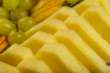 Very nice and artistically sliced fruits on a platter.