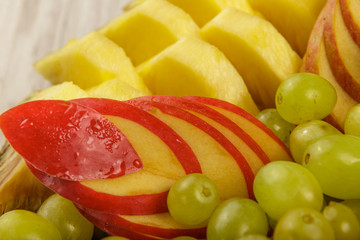 Very nice and artistically sliced fruits on a platter.