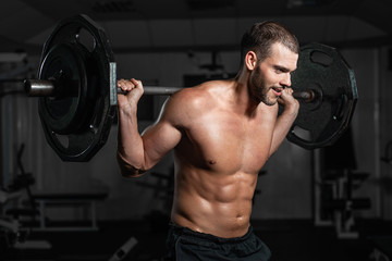 Male training with barbell, pumping legs
