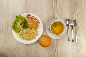 A lunch with a pasta chop with pasta and a roll.