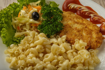Pasta with a piece of grilled meat and salad.