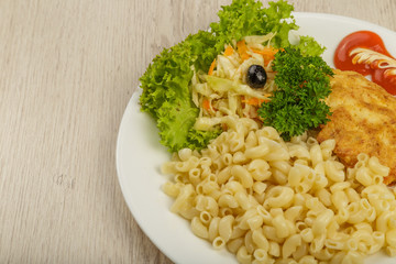 Pasta with a piece of grilled meat and salad.