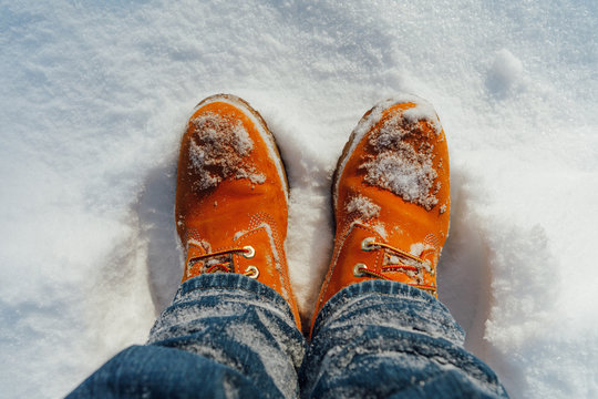 orange winter shoes in snow