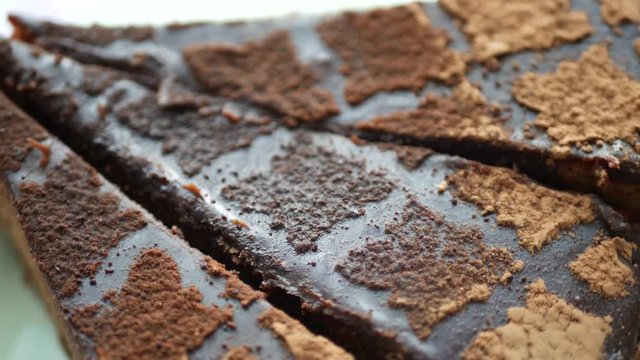 Piece og dark delicious chocolate cake on plate on table
