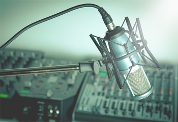 Microphone and digital studio mixer on background