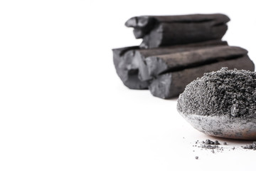 Activated charcoal powder on white background. copy space