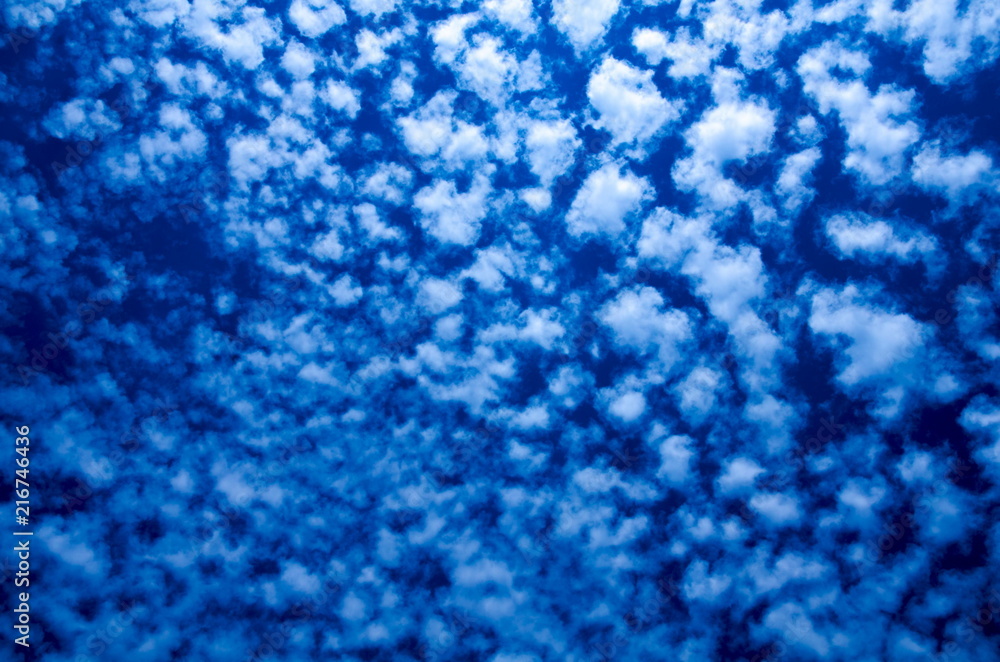 Poster a bright blue background consisting of clouds of jerky structure in computer processing.