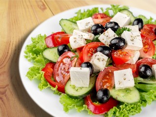 Greek salad with fresh vegetables on desk