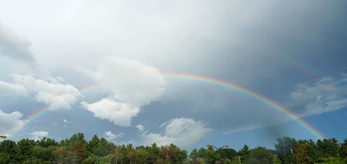 landscape of rainbow in the sky after thunderstorm