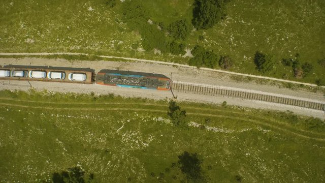 Aerial shot of a train transporting cars