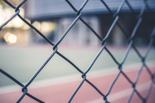 Front view from a metal grid of a sports court. Through this image we can see sports, game, pattern, outside sports concept