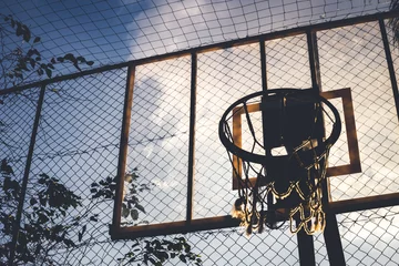 Fotobehang Side and bottom view from a basketball hoop in a daylight. Through this image we can see everything about sports, game, competition, teans, dayoff and much more. © Thi Soares