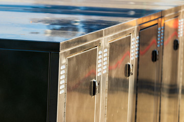 Bright shiny aluminum bicycle lockers close up