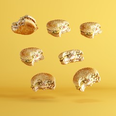 Bergers floating on yellow background. minima food idea concept.
