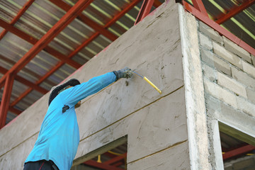 Worker labor building wall and UPVC groove line with plaster cement