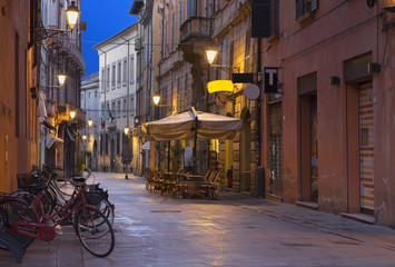 Fototapeta na wymiar Reggio Emilia - The street of the old town at dusk.