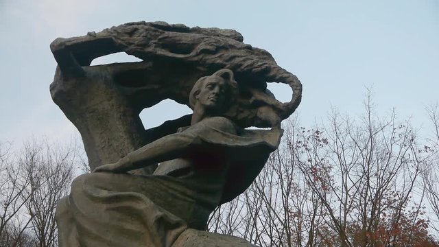 Close up of the Chopin Monument in Lazienki Park in Warsaw, Poland with the statue on the left of the frame