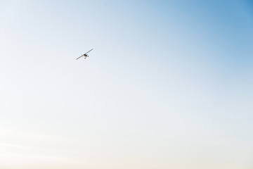 An airplane in the air against a blue sky. 
