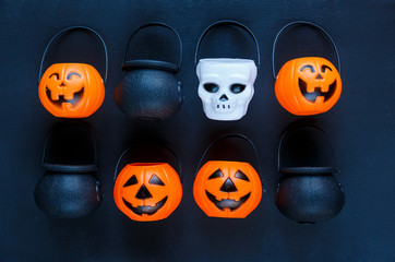 Halloween background with pattern of jack lanterns, cauldrons, skulls on dark blue background. creative decoration, celebration, autumn concept 