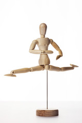 Wooden Dummy human jump isolated white.