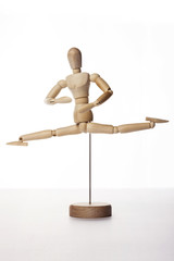 Wooden Dummy human jump isolated white.