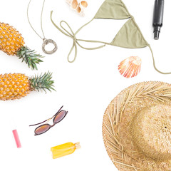 Summer tropical concept. Pineapple fruits, sun glasses, hat and swimwear on white background. Flat lay, top view. Copy space.