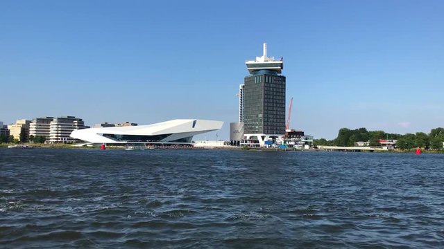 View on the north coastline of Amsterdam: in the center the EYE film museum and the A'DAM Tower as seen from the IJ water.