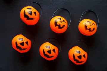 Halloween background with pattern of jack lanterns on black background.  creative decoration, celebration, autumn concept 