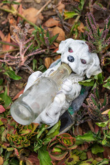 Whimsical Garden Art Decoration - White Puppy Holding a Bottle