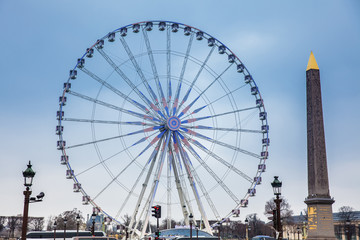 Wheel of Paris and Luxor Obelisk at the Place de la Concorde in a cold winter day