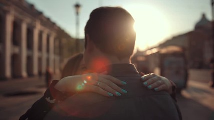 Attractive guy and girl have romantic dance in the city. They dancing slowly, emotionally, smiling and laughing. Whirling and Rotating at crowded place. 4k Ultra HD
