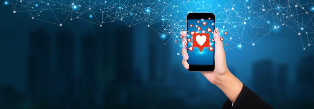 View of a businesswoman holding Like notification on a social media, social media concept