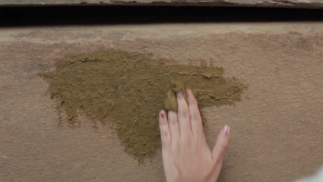 Sade village traditional daily activity, moping with fresh cow dung. A tourism in Lombok, Indonesia