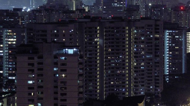 Timelapse tilt up of urban landscape night Singapore Asia