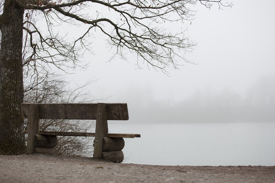 Empty Bench On The Edge Of A Lake Shore In Fall Symbol For Serenity Piece Quiet And Meditation