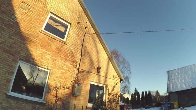 Time Lapse of house taken in winter in Lithuania, Sun Shadows are crowling on the wall, litlle bit movement.