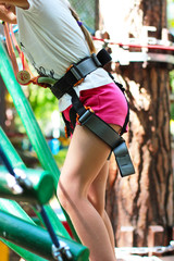 Cute girl 8 years old in adventure rope town, selective focus