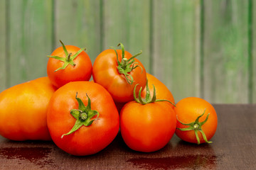 Bunch of tomatoes on the background of a wooden facade