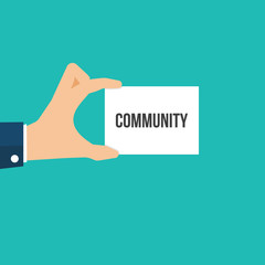 Man showing paper COMMUNITY text