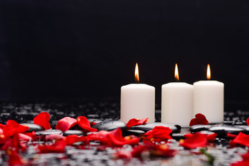 Still life with red rose ,petals with candle and therapy stones 
