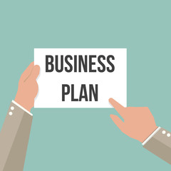 Man showing paper BUSINESS PLAN text