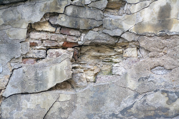 Old wall with bricks under plaster