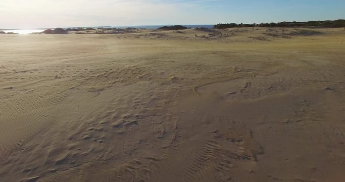 Aerial shot of person running on sand dunes Nags Head, North Carolina.