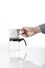woman hand a coffee port for hand drip coffee isolated white.