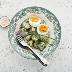 Potato salad farmer market with fresh vegetables cucumber, radish and organic eggs with dill and chives onions. Top View.
